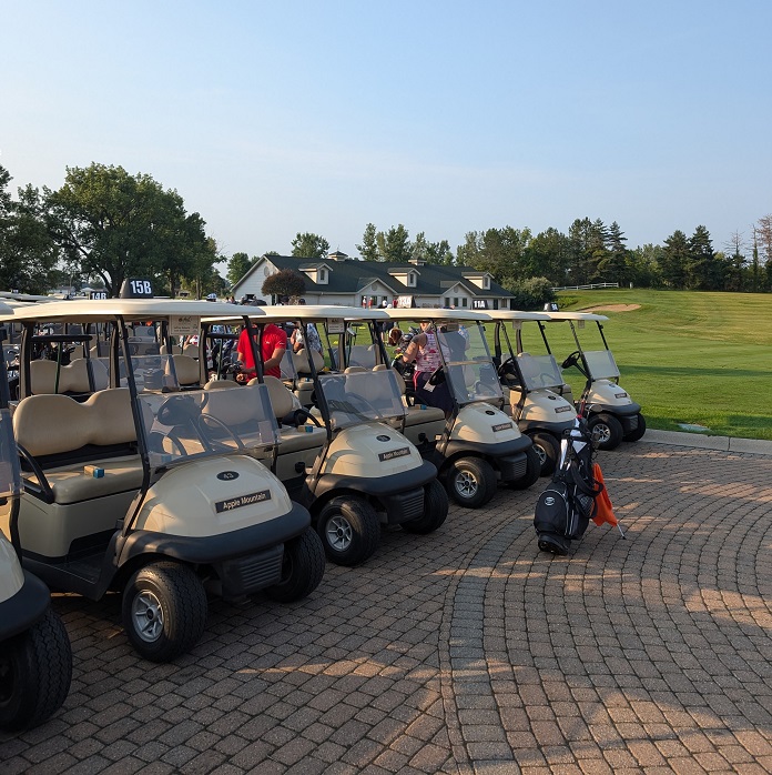 golf carts lined up at Apple Mountain before the 2024 Alumni Legacy Golf Outing begins